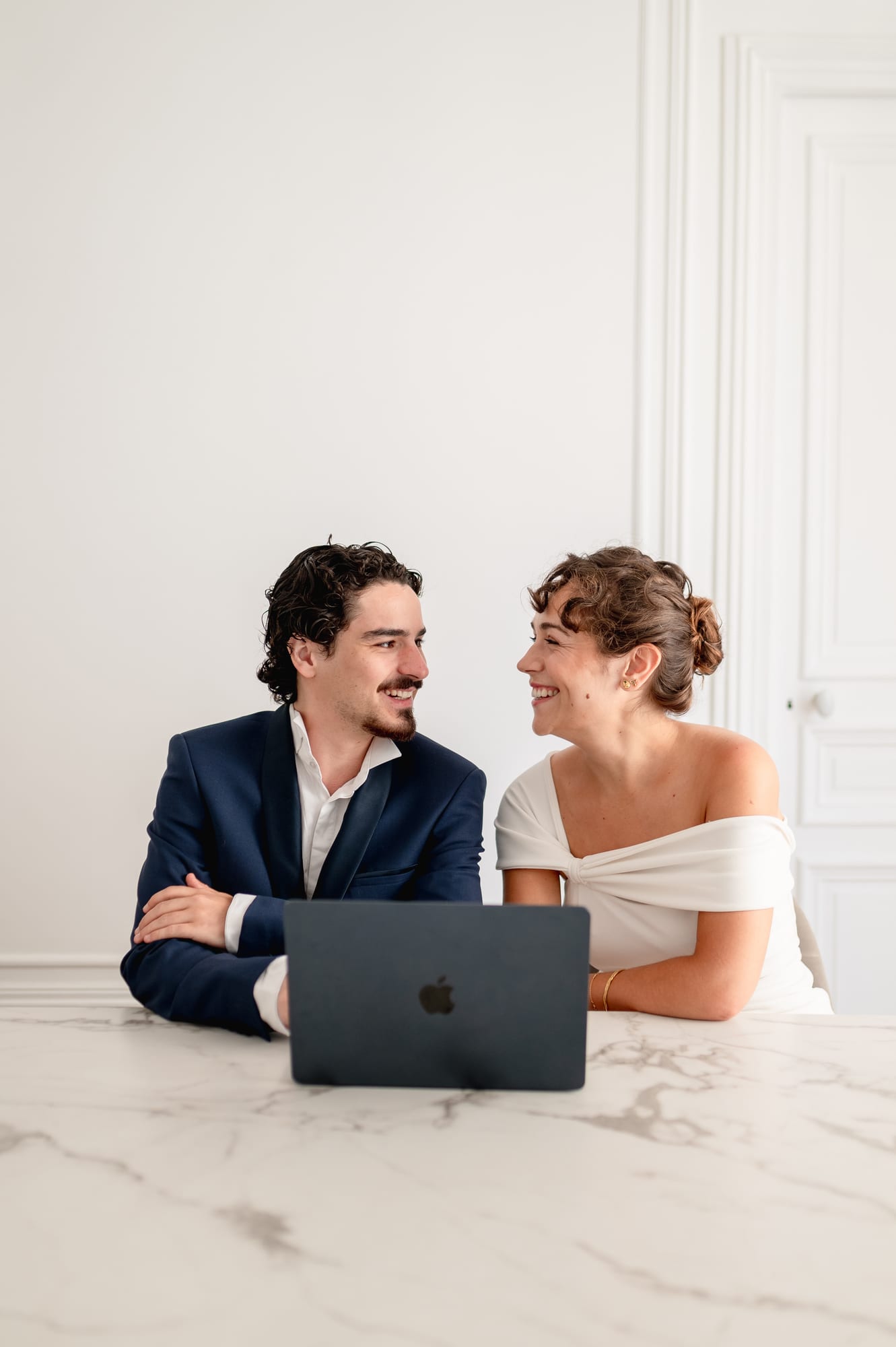 A couple exchanging a glance in front of their Maison.S Wedding Client Portal